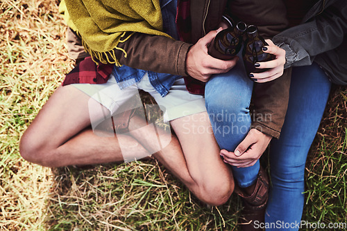 Image of Drinks on the mountain. High angle shot of an affectionate young couple enjoying a hike in the mountains.