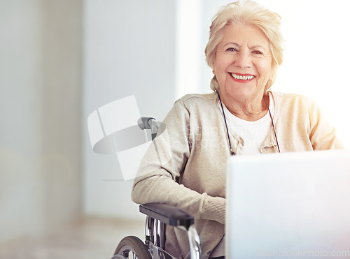 Image of Young at heart... slightly older in other places. a senior woman using a laptop while sitting in a wheelchair.
