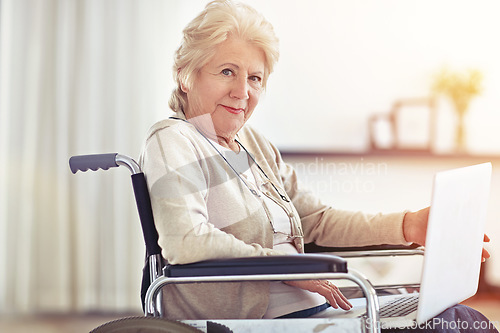 Image of Wheelchair-bound but she access to the world wide web. a senior woman using a laptop while sitting in a wheelchair.