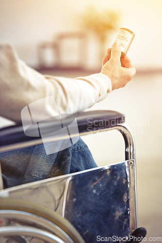 Image of This old body is full of aches and pains. a senior woman sitting in a wheelchair holding a container of medincine.
