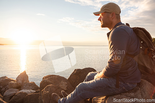 Image of Going for a hike is a chance to reflect. a man looking at the ocean while out hiking.