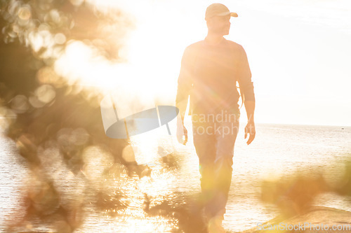 Image of Hiking is always a good idea. a man wearing his backpack while out for a hike on a coastal trail.