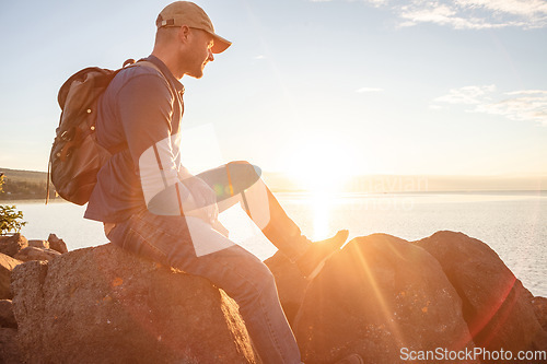 Image of Go for a hike, stay for the scenery. a man looking at the ocean while out hiking.