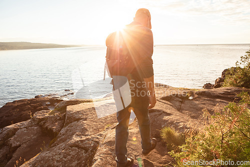 Image of Hiking is the perfect way to sweat out your frustrations. a man wearing his backpack while out for a hike on a coastal trail.