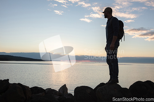 Image of Hiking soothes and clears the head. a man wearing his backpack while out for a hike on a coastal trail.