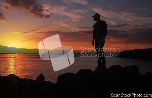 Image of Im always on an adventure to get closer to the sky. a man wearing his backpack while out for a hike on a coastal trail.