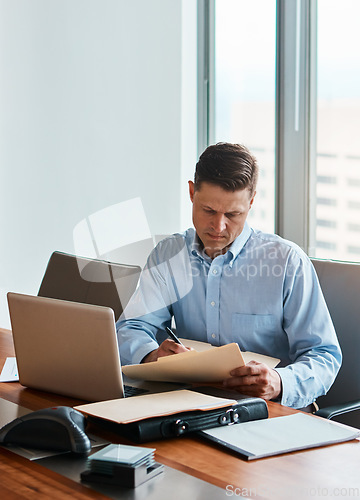 Image of Ill just sign and send it back through e-mail. a mature businessman working at his desk.