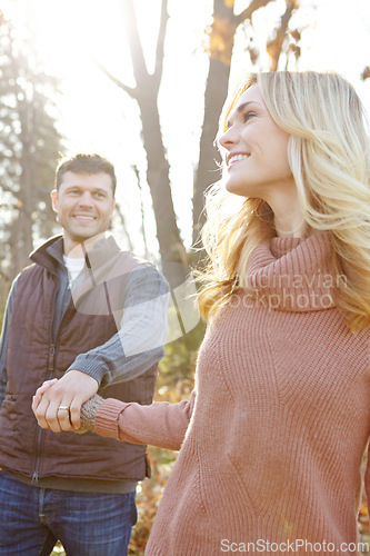 Image of Taking a nature walk together. An affectionate and romantic young couple spending time together in the woods.