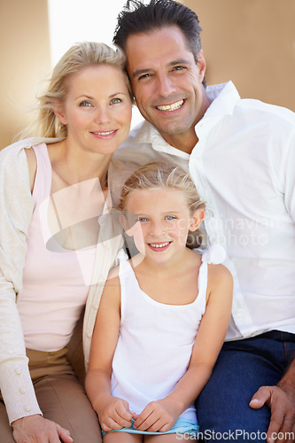 Image of Delighted family of three. Two delighted parents sitting with their adorable daughter.