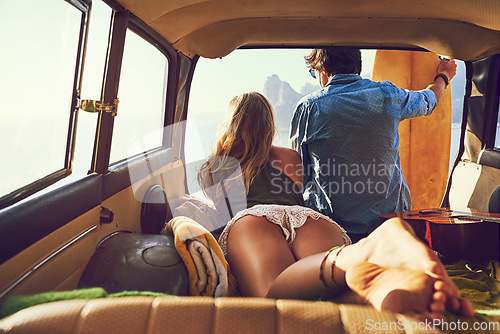 Image of The best spot to check out the surf. Rearview shot of a young couple relaxing inside their car during a roadtrip.