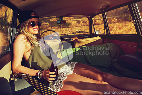 Image of Summer doesnt get better than this. a young woman relaxing in the back of her car on a roadtrip.