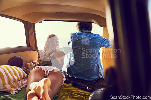 Image of Adventure is out there. Rearview shot of a young couple relaxing inside their car during a roadtrip.