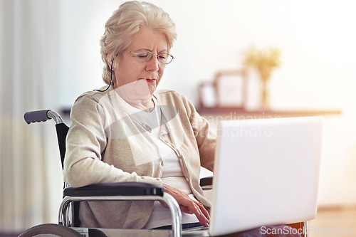 Image of Staying in touch with her family. a senior woman using a laptop while sitting in a wheelchair.