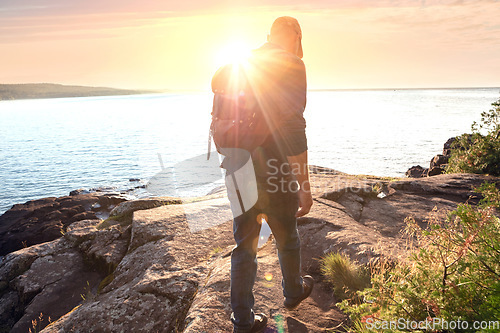 Image of Hiking pushes you to find new trails. a man wearing his backpack while out for a hike on a coastal trail.