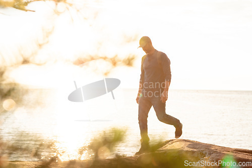 Image of Hiking gets me closer to nature. a man wearing his backpack while out for a hike on a coastal trail.