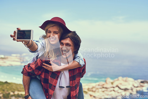 Image of Snapping a selfie against a beautiful backdrop. an affectionate young couple taking selfies while hiking in the mountains.