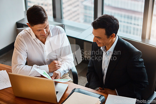 Image of I know just how to solve this problem. two businessmen having a discussion while sitting by a laptop.