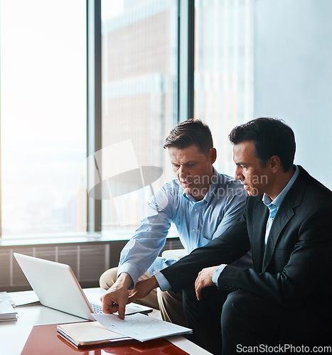 Image of Preparation is never a waste of time. two businessmen having a discussion while sitting by a laptop.