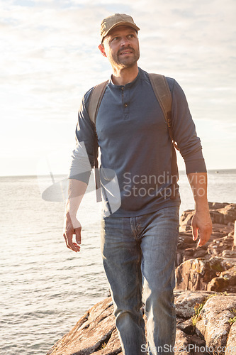 Image of We learn something new on every walk through nature. a man wearing his backpack while out for a hike on a coastal trail.