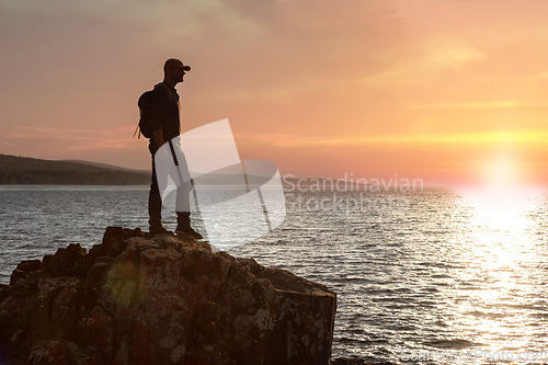 Image of I have a need to get close to nature. a man wearing his backpack while out for a hike on a coastal trail.