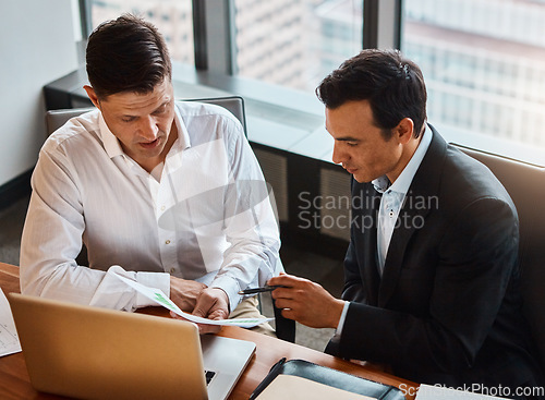 Image of Going into partnership is the right solution for you. two businessmen having a discussion while sitting by a laptop.