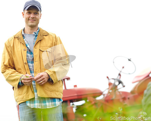 Image of The happiest life is a simple one. Portrait of a farmer standing in a field with his tractor parked behind him - Copyspace.