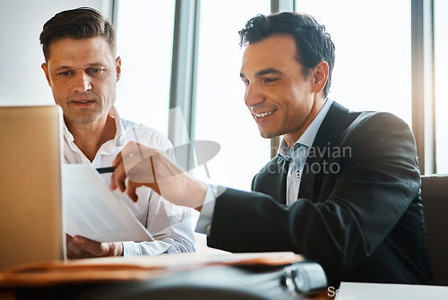 Image of These are really impressive. two businessmen having a discussion while sitting by a laptop.