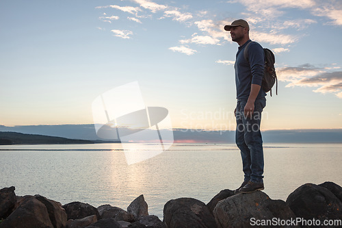 Image of We cant have everything but we can have adventures. a man wearing his backpack while out for a hike on a coastal trail.