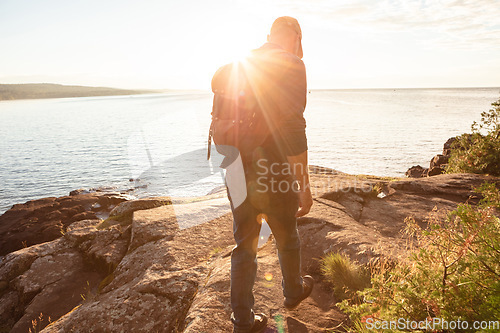 Image of A hike will help you to discover your strengths. a man wearing his backpack while out for a hike on a coastal trail.