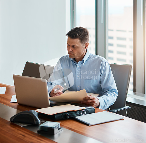 Image of With the internet, nothing is unreachable. a mature businessman working at his desk.