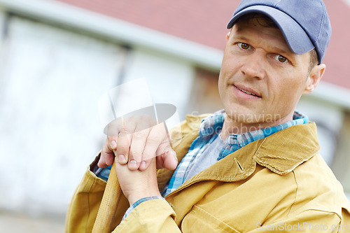 Image of Ready to plant the years crops. Portrait of a man leaning on a gardening tool with copyspace.