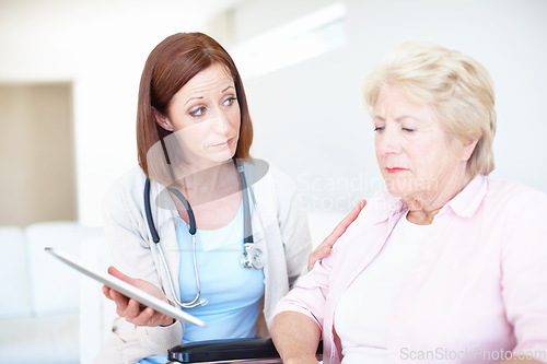 Image of Consoling her after the shock - Senior Health. Elderly patient receives some comfort from her nurse after receiving a bad diagnosis.