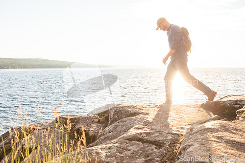 Image of I love to challenge myself. a man wearing his backpack while out for a hike on a coastal trail.