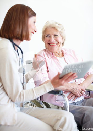 Image of Appreciating her professional and friendly care. Elderly patient is delighted by the good news her nurse has just given her.