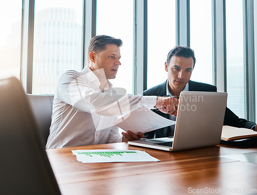 Image of Were better when we work together. two businessmen having a discussion while sitting by a laptop.