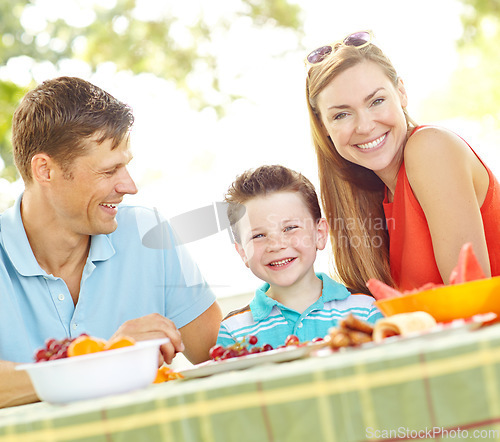 Image of Are you ready for lunch. A happy young family relaxing in the park and enjoying a healthy picnic.