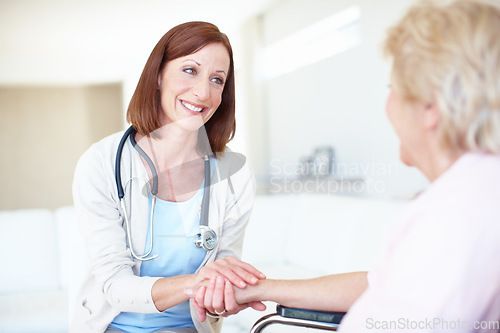 Image of A patients needs are her first and foremost priority - Senior Care. Mature nurse consoles an elderly patient with kind words while holding her hand.