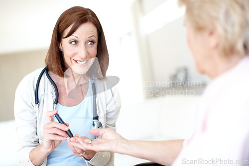 Image of Dont worry, this wont hurt a bit. Mature nurse checking an elderly patients blood sugar levels with a prick to the finger.