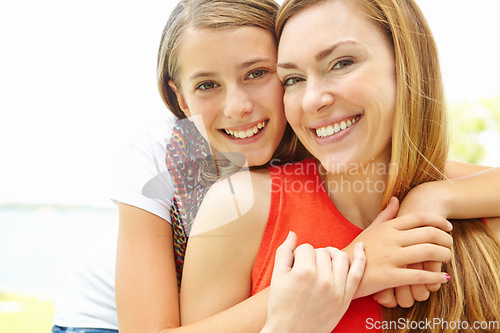 Image of We have a strong bond. Smiling mother and daughter embracing while outdoors.