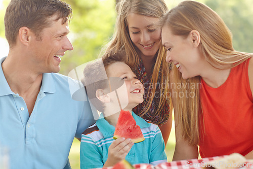 Image of Spending time together in the park. Happy attractive family having a picnic in the park.