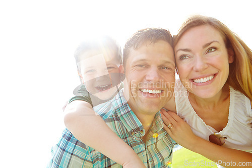 Image of Enjoying the sunshine. A cute young family spending time together outdoors on a summers day.