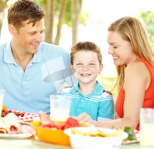 Image of I love family time. A happy young family relaxing in the park and enjoying a healthy picnic.