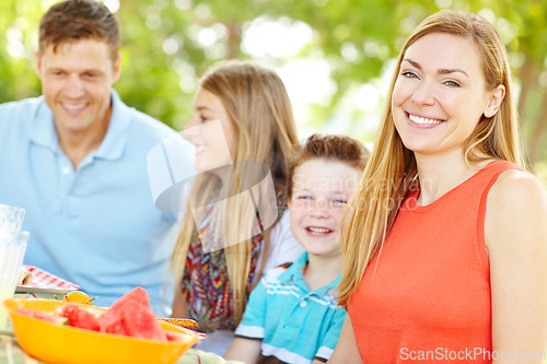 Image of Having a family is so fulfilling. A happy young family relaxing in the park and enjoying a healthy picnic.