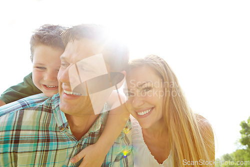 Image of Secure in his parents love. A cute young family spending time together outdoors on a summers day.