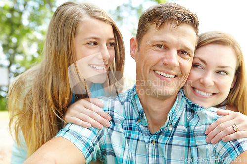 Image of Hes their number one. A happy young family relaxing together on a sunny day.