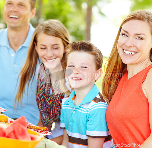 Image of Enjoying a healthy lifestyle as a family. A happy young family relaxing in the park and enjoying a healthy picnic.