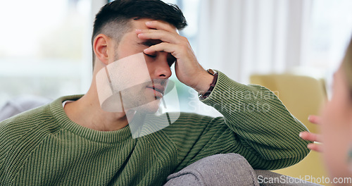 Image of Man, headache and fight on sofa in home with discussion, talk and frustration with spouse for infidelity, lies or cheating. Husband, hand and stress for conversation, divorce and conflict with wife