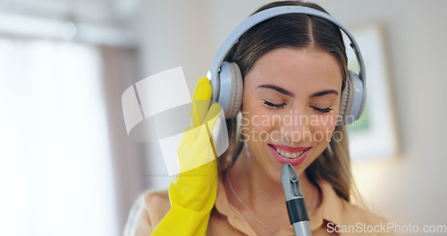 Image of Woman, headphones and cleaning house or music, smile and streaming radio or audio, sound and song. Happy female person, sweeping and karaoke at home, freedom and housekeeping or podcast for hygiene