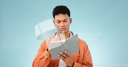 Image of Thinking, notebook and writing with man, problem solving and ideas with creativity on a blue background. Person, guy and model with planning, vision or education with decision, choice and knowledge