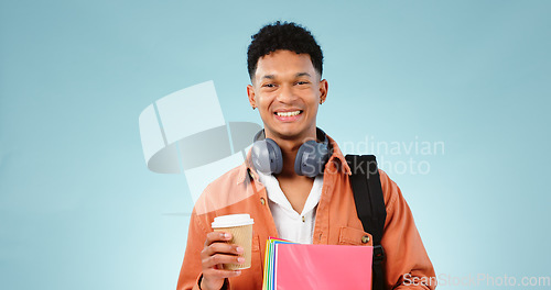 Image of Student, coffee and portrait of man with books and backpack in studio for university or college. Education, happy and person smile with headphones, notebooks and bag for learning on blue background